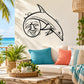 Black line-art dolphin wall decal with a smiling moon face and small star accents