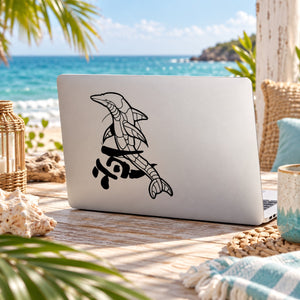 Dolphin line-art decal on light-colored laptop lid