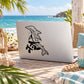 Dolphin line-art decal on light-colored laptop lid