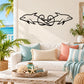 Dolphin tail vine wall decal, black line art on light wall.