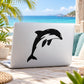 Leaping dolphin vinyl decal, bold black silhouette on light surface