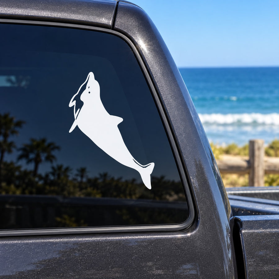 White dolphin swimming up vinyl decal on car window glass