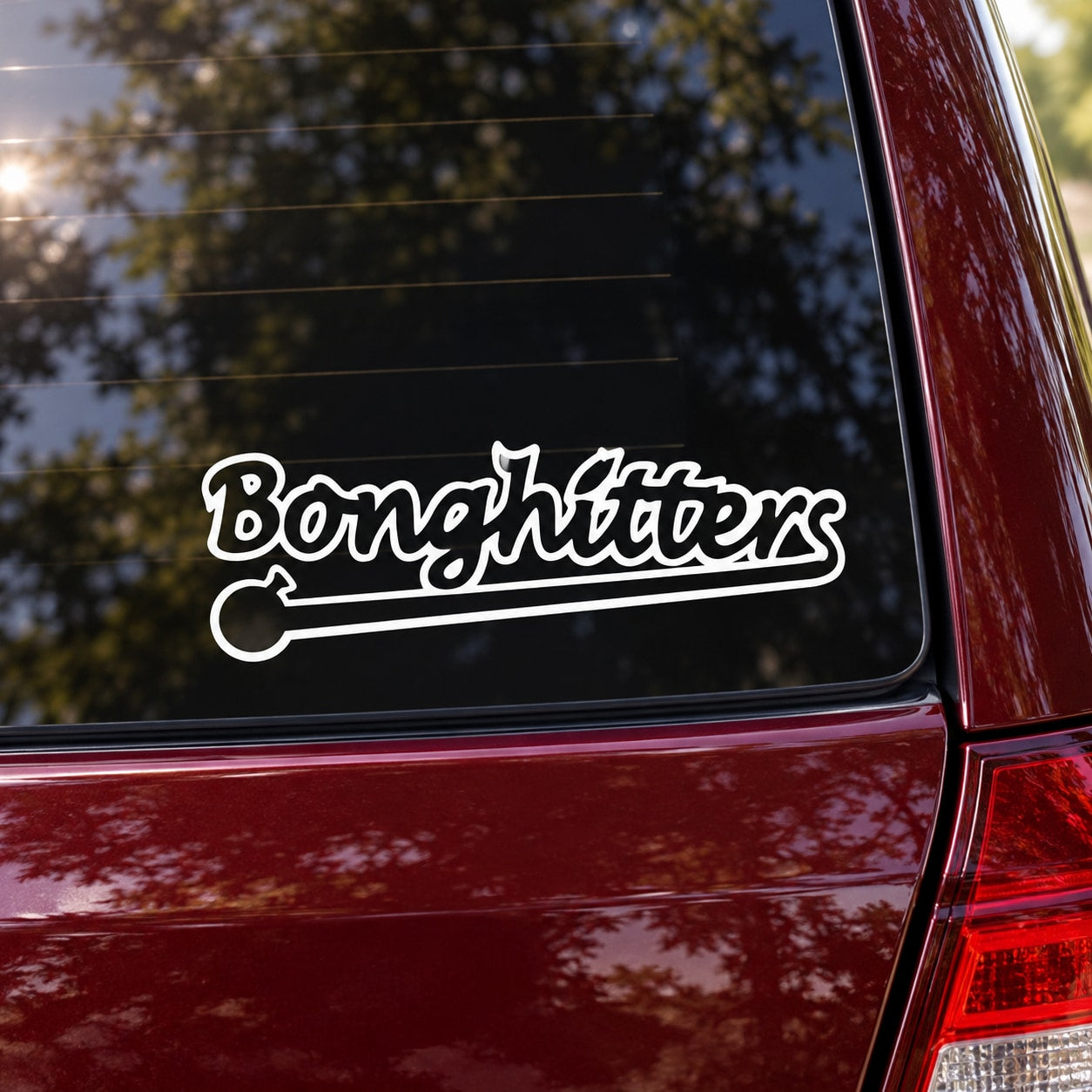 Bonghitters decal sticker with bold script and outline, applied on a car window