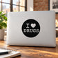 Black circular decal reading "I ♥ DRUGS" on a light laptop cover