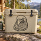 Eagle head decal in black line art on a light gray cooler