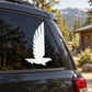 White flying eagle decal on a car side window panel