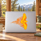 Orange flying eagle decal with flame-like wings on a laptop