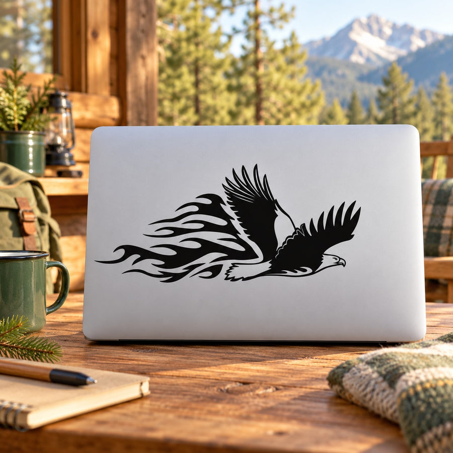 Black flying eagle decal with flame trail on light laptop lid