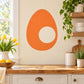 Orange egg-shaped wall decal with white yolk circle