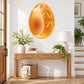 Decorative Easter egg sticker with open yolk center, orange with gold patterns