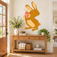 Easter bunny holding decorated egg wall sticker, brown cartoon style with pink ribbon