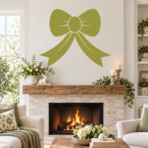 Green bow decal with circular center and dangling ribbon, above fireplace wall