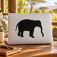 Black elephant silhouette decal on a light laptop lid