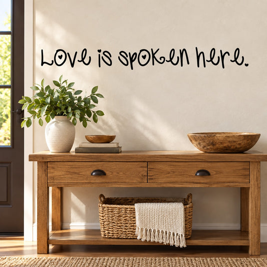 Wall decal with cursive quote: “Love is spoken here.”