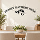 Black wall quote decal with 'FAMILY GATHERS HERE' text and decorative swirl