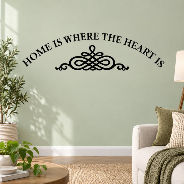 Black wall decal: arched 'HOME IS WHERE THE HEART IS' text with heart knot icon