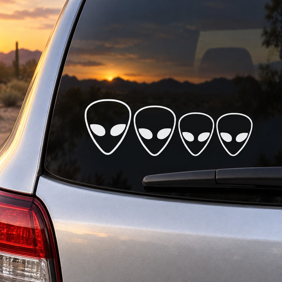 Alien head family kit decal set: four white alien faces on car rear window