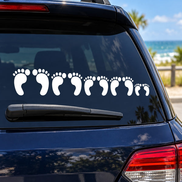 White footprint family decal strip on dark car rear window