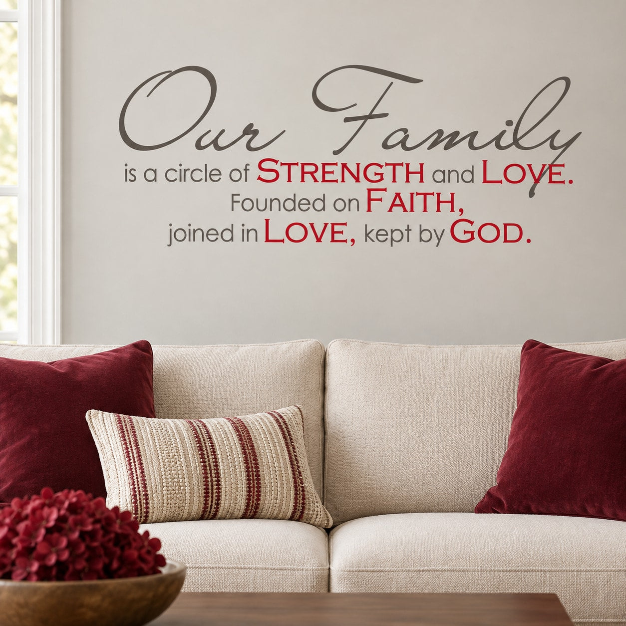 Family quote wall decal with “Our Family” circle text in dark lettering with red highlights