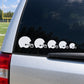 Set of white football helmet decals in a row on a dark car window