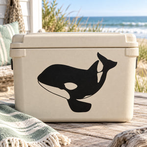 Black orca whale decal on light-colored storage container