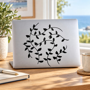 Vines decal with black leafy vines and swirls on a light laptop cover