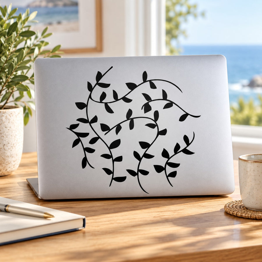 Vines decal with black leafy vines and swirls on a light laptop cover