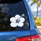 Flower decal with white bloom and small dot cluster on car window