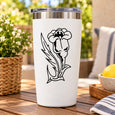 Outlined flower decal on a white tumbler with a black outlined animal face graphic