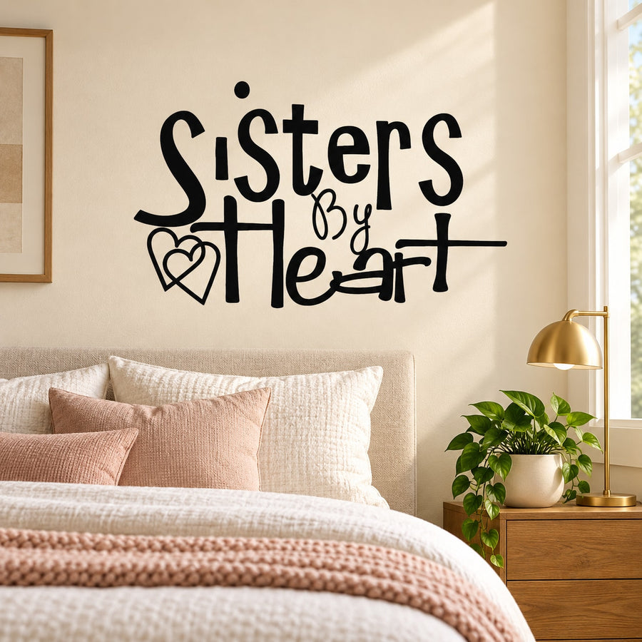 Wall decal reading “Sisters by heart” with heart icons