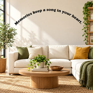 Wall decal text: “Memories keep a song in your heart” in black script