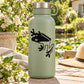 Black frog hiding decal on light green water bottle