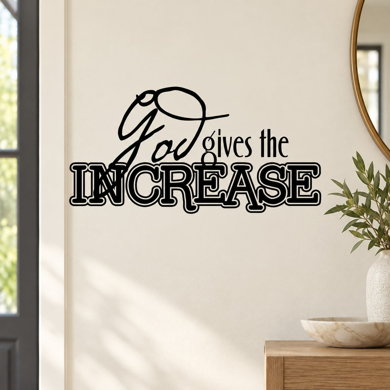 Black wall decal with script quote “God gives the INCREASE” and decorative flourish