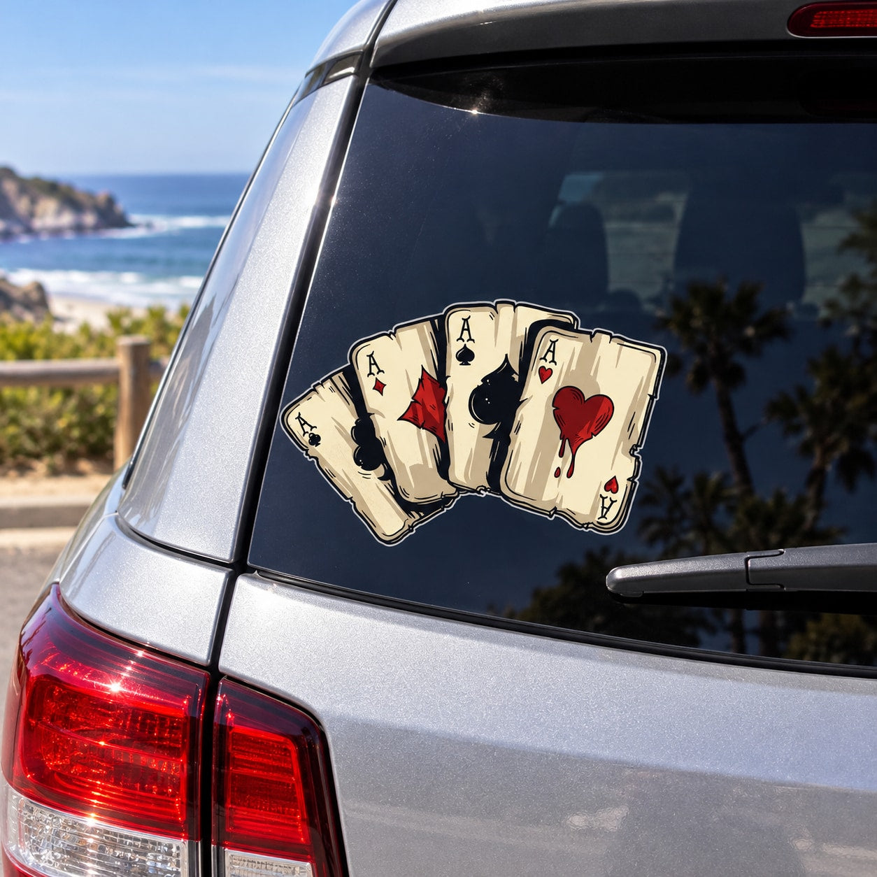 Four-ace playing card sticker with cream, black, and red cards on a window