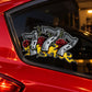 Black car window sticker with stylized 777, red roses, and yellow flames
