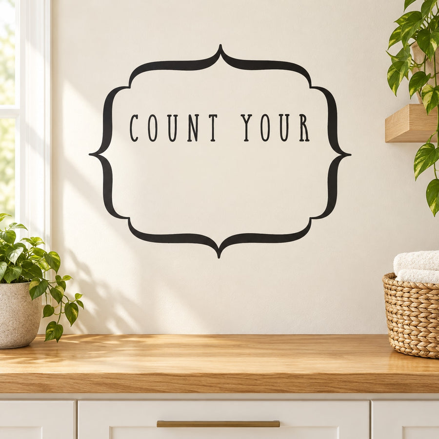Black wall decal with ornate frame and 'COUNT YOUR' lettering