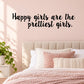Wall decal with black cursive text: “Happy girls are the prettiest girls.”