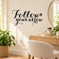 Black Follow your arrow wall decal in flowing cursive