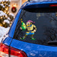 Car window elf decal with green oblong ornament, colorful cartoon figure on black