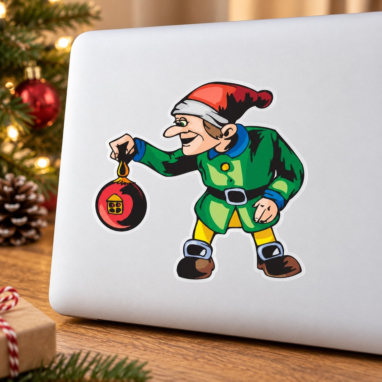 Elf decal with red ball ornament on a white surface