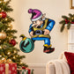 Cartoon elf sticker holding a teal ball ornament, black hat and blue outfit