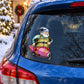 Oblong elf sitting decorative sticker on dark car window