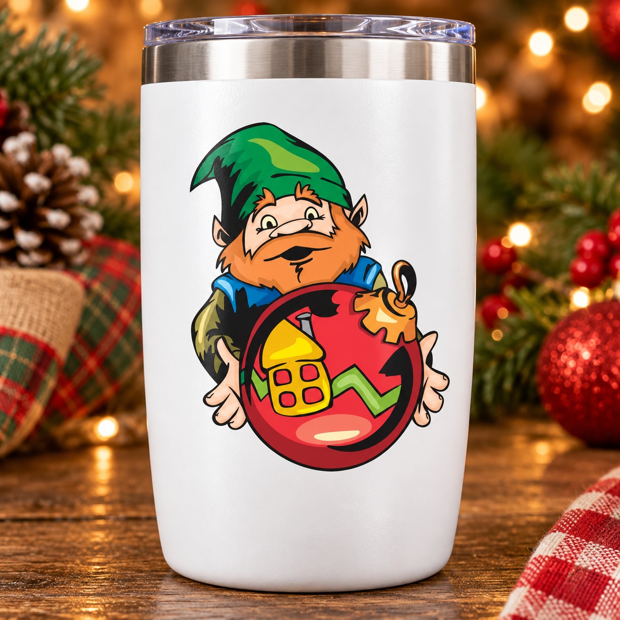 White tumbler with elf graphic sticker holding red ball ornament