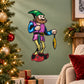 Cartoon elf sticker holding a yellow ornament, green cap, colorful outfit