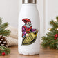 White bottle with elf cartoon sticker holding tan oblong ornament