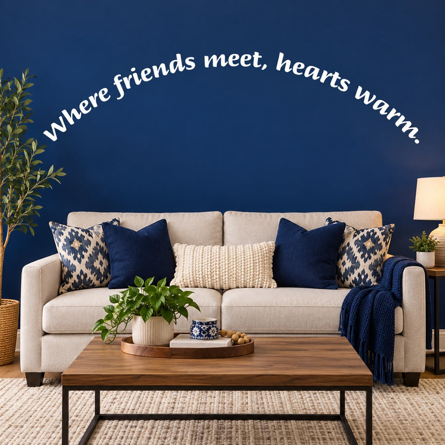 Wall decal: white cursive quote 'Where friends meet, hearts warm'.