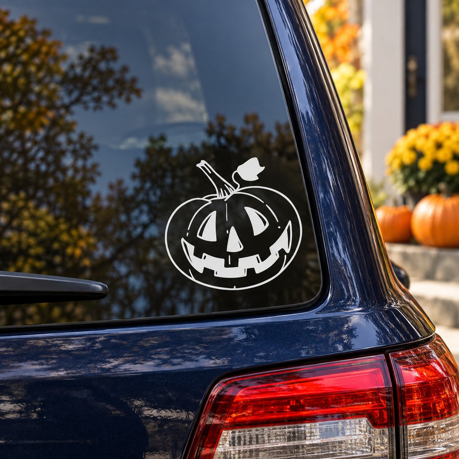White smiling jack-o-lantern window decal on dark car glass, circular outline.