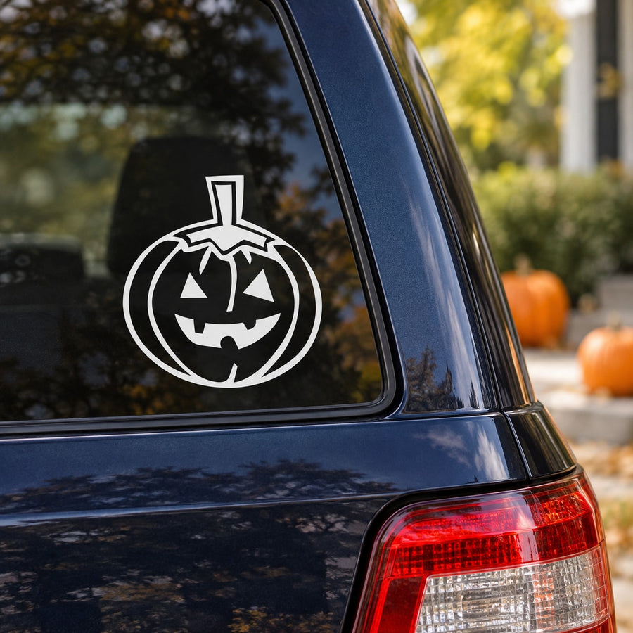 Spooky jack-o-lantern decal with white outline pumpkin face on car window