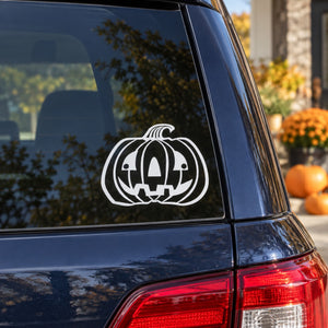 White jack-o-lantern face decal on car window