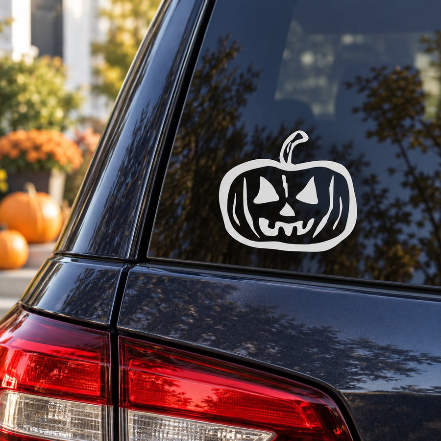 White carved jack-o-lantern face decal on a car window